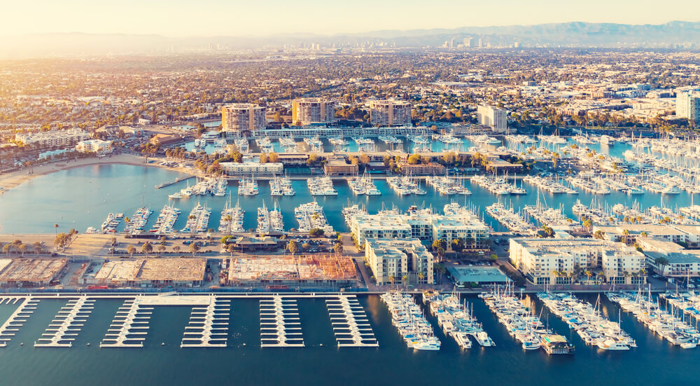 The Best Places for Sailing in the US: 8 Amazing Holiday Destinations 7 This picture shows one of the marinas in Los Angeles and you can see a lot of boats lining up here. With the skyscrapers and mountains in the background, it is a pretty sight during sunset as you can see
