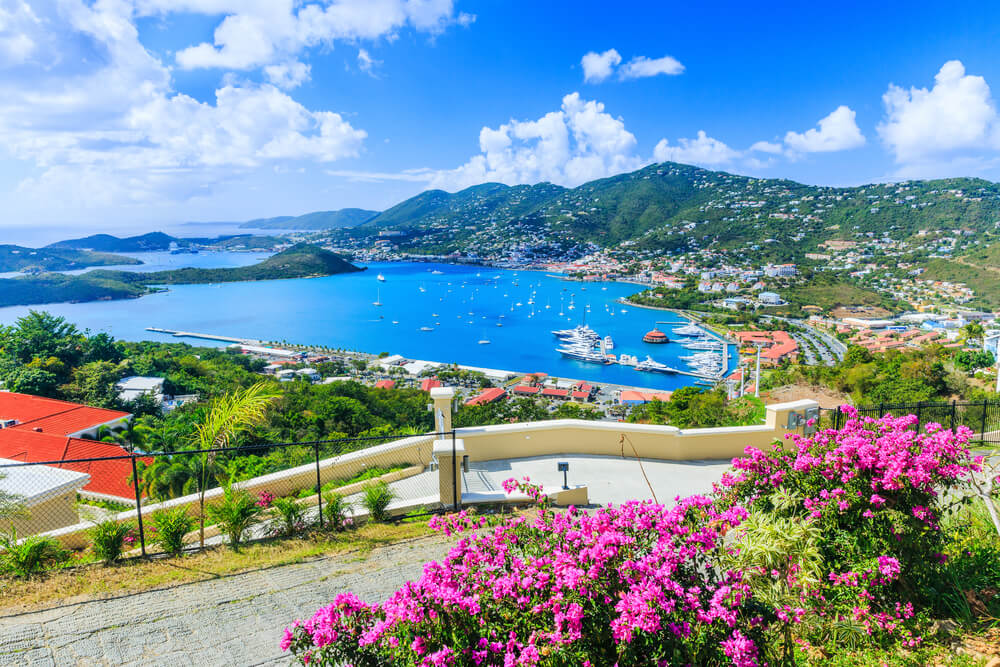The Best Places for Sailing in the US: 8 Amazing Holiday Destinations 4 The picture shows St Thomas, which is part of the US Virgin Islands and many mega yachts mooring at the marina. Framed by lush green mountainous landscapes and pretty pink flowers, it is a great destination for sailing in the US