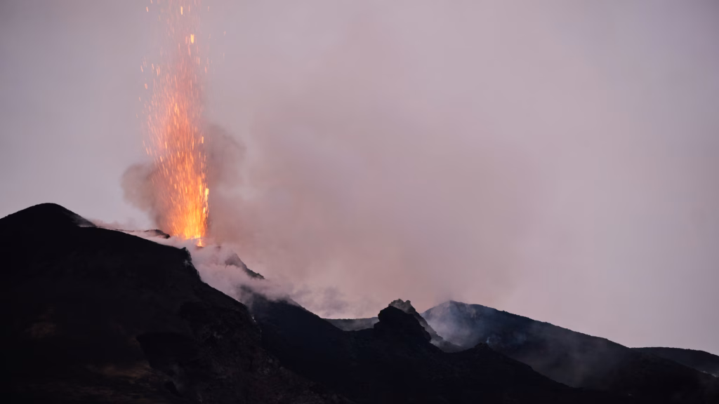Stromboli erupting at dusk, seen from a yacht anchored offshore in the Aeolian Islands
